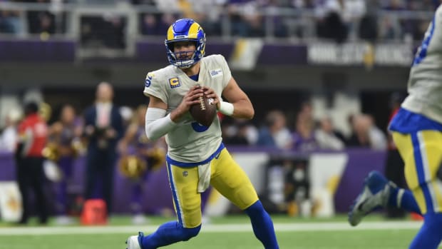 Dec 26, 2021; Minneapolis, Minnesota, USA; Los Angeles Rams quarterback Matthew Stafford (9) rolls out to throw a pass against the Minnesota Vikings during the second quarter at U.S. Bank Stadium. Mandatory Credit: Jeffrey Becker-USA TODAY Sports
